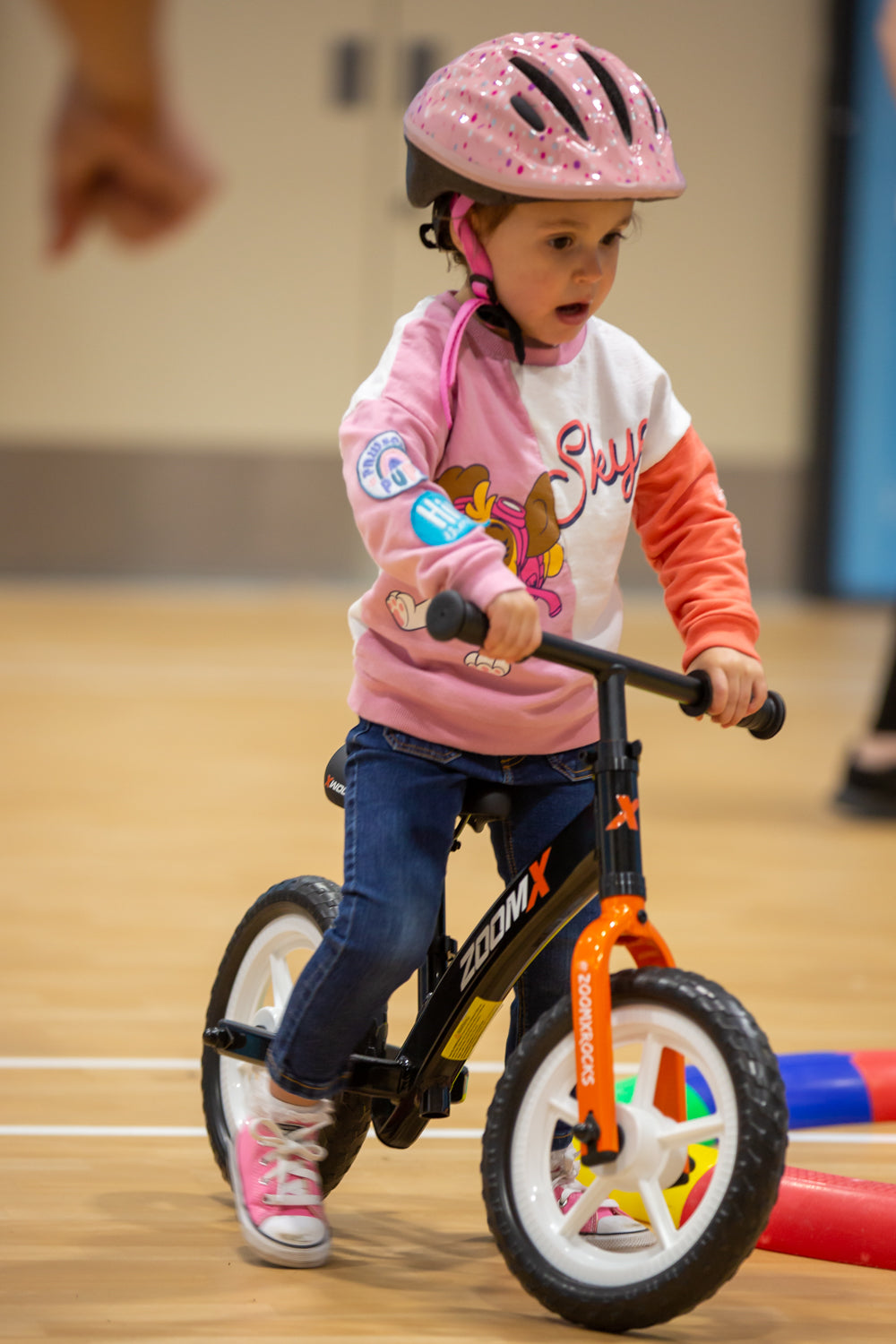 child riding balance bike